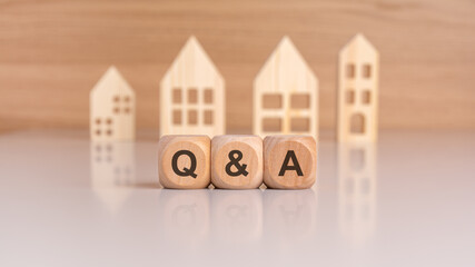 Sticker - Cubes with message Q and A surrounded by wood home. Question and answer about housing problems