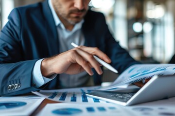 Close up of professional business man reading financial report by using tablet while making decision for investment. Skilled investor planning marketing strategy while checking at data analyze. AIG42.