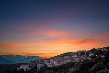 Sticker - Dawn breasking over the town of Sartène in southern Corsica with the Bavella mountains in the distance