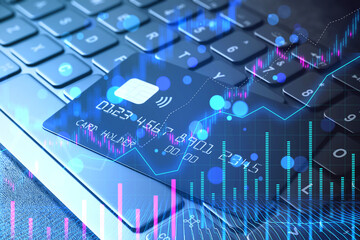 Poster - Credit card over keyboard with financial stock market graphics, creative double exposure concept on a dark background