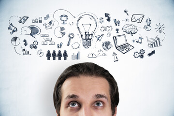 Poster - A man looking upwards with doodle icons and concepts of business and creativity surrounding his head, against a light background