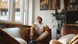 © Yuriy - A pensive guy  sits on a sofa in a bright room