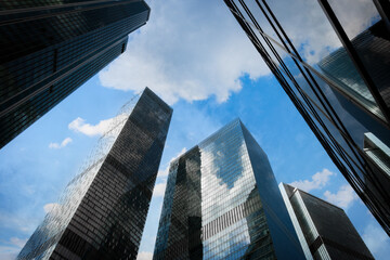 Poster - Tall office skyscrapers with sky reflection in windows, business concept banking background