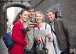 © caftor - Tourists taking selfie on old street of European city