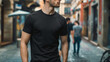 © irabublikova - A man in a black shirt stands on a city street