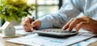 © DJSPIDA FOTO - Professional real estate agent calculating interest rates and managing numbers for residential properties, representing real estate concept