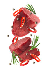 Wall Mural - Pieces of raw beef meat, pepper slices, rosemary and peppercorns in air isolated on white