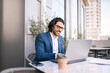 © Renata Hamuda - A young businessman is sitting at a table with a laptop enjoying working out of the office