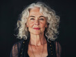 © KC Radler - Portrait of an Empowered Older Woman with Silver Hair and a Confident Expression, Wearing a Black Top Against a Dark Background