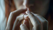 © Generative AI - Upset woman holding wedding ring close up cropped image took off jewellery demonstrate show it as symbol of divorce family split break up legally dissolve wifehood with husband bustup  : Generative AI