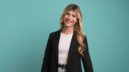 Wall Mural - Cheerful transgender businesswoman looking at camera as she laughs on blue background