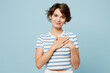 © ViDi Studio - Young smiling happy grateful woman wearing striped t-shirt casual clothes put folded hands on heart look camera isolated on plain pastel light blue cyan background studio portrait. Lifestyle concept.