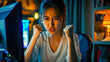 © Nikname - Asian young woman sitting in front of the computer waving her fists in anger.