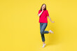 © ViDi Studio - Full body young smiling happy charming nice woman wear pink t-shirt casual clothes stand put hand on face raise up leg isolated on plain yellow orange background studio portrait. Lifestyle concept.