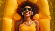 © Muzamil - Top view of happy African American female in sunglasses with Afro hair lying on inflatable yellow air mattress near swimming pool and listening to songs on headphones