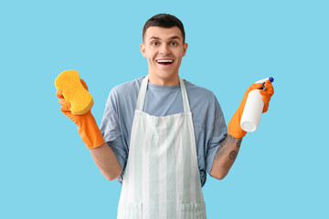 Sticker - Young tattooed man with sponge and detergent on blue background