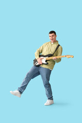 Poster - Cool young man playing electric guitar on blue background