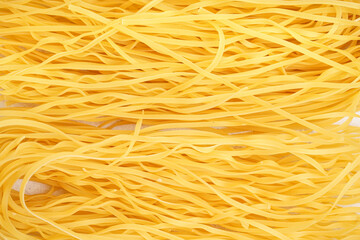 Poster - Delicious uncooked spaghetti pasta as background