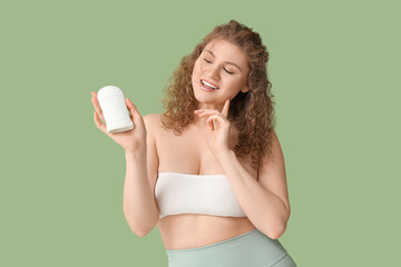 Poster - Beautiful young woman with deodorant on green background