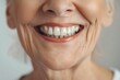 © Alexey - Smile with implanted teeth of woman over 60 years old. Close up white teeth of mature old lady. Dental appointment, dentistry concept.