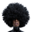 © Miso Ai - Striking portrait of a person with an afro hairstyle, featuring dramatic lighting and contrast against a plain background.