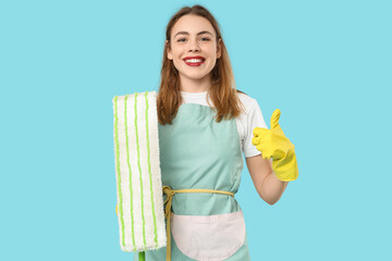 Poster - Pretty woman with mop showing thumb-up on blue background