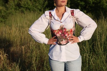 Wall Mural - Woman in beautiful corset outdoors, closeup. Space for text