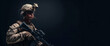 © sornram - A soldier in full combat gear stands against a dark background, holding a rifle.