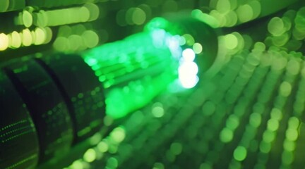 Animation of fiber optic beam used for transmitting data with the high speed and digital film projector lens and a optical fiber wire with coding language background and a green coding background  