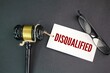 © Fauzi - judge's gavel, glasses and a paper tag with the word disqualified. concept of disqualification