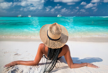 Wall Mural - Beautiful young pretty brunette girl in black bikini  her perfect sport sexy body relax in sea of white sand paradise tropical beach at sunny day. Summer concept