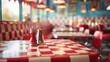 © tashechka - A nostalgic retro diner featuring a red checkered tablecloth, bright decor, and classic chrome condiment holders on the table.