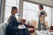 © Kostiantyn - Human resources manager in eyewear sitting at office is making welcome sign to candidate on job