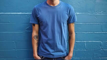 Wall Mural - A man wearing a simple blue t-shirt. Focus on simplicity