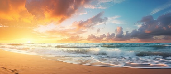 Wall Mural - Sunrise over a serene beach with a scenic seascape and fluffy clouds in the sky, perfect for a summer vacation with a peaceful ambiance and copy space image.