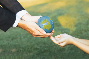 Sticker - Businessman hand giving Earth globe to little boy as Earth day concept as corporate social responsible to contribute greener environmental protection for sustainable future generation. Gyre