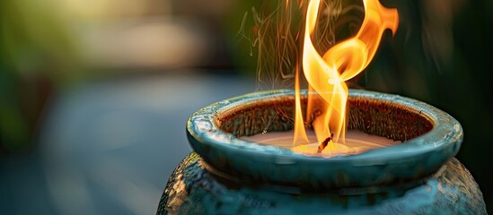 Close up shot of fire burning candle in ceramic pot. with copy space image. Place for adding text or design