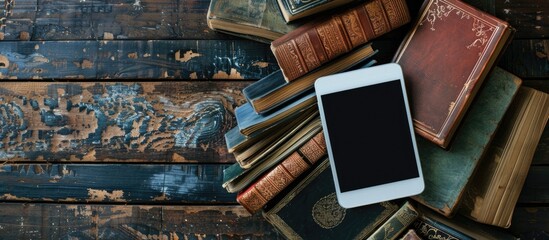 Poster - Ebook, digital tablet device, with old real books nearby on the rustic background. with copy space image. Place for adding text or design