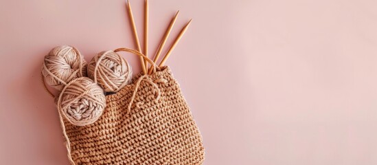 Handmade and craft. Crochet brown bag with crochet work. Yarn and wood crochet needles on pastel background. with copy space image. Place for adding text or design