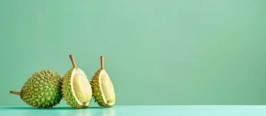 Sticker - Durian fruit with cut in half on the table pastel background. Copy space image. Place for adding text and design