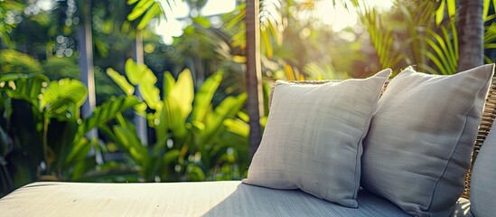 Wall Mural - Comfortable pillow on sofa decoration outdoor patio with tropical and nature view. Copy space image. Place for adding text and design