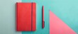 © Ilgun - red notebook and pen Isolated on pastel background Design. Copy space image. Place for adding text and design