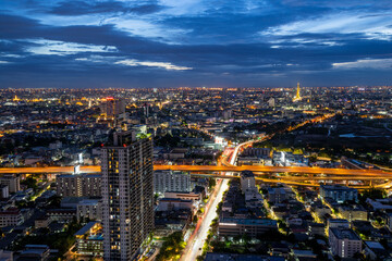 Wall Mural - Crowded city with modern city and car traffic jams in high angle view. and the top of the bridge at a high angle See the blue horizon which is in Bangkok, Thailand