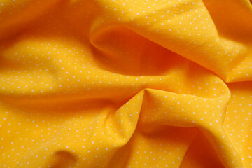 Poster - Rumpled amber yellow viscose fabric with white pin dot pattern