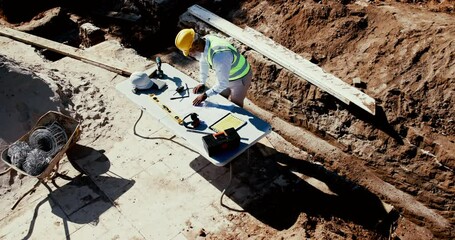 Wall Mural - Architect, mature man and blueprint of building, construction or digging site for planning foundation of mining infrastructure safety. Engineer, design and excavation of project development progress