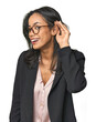 © Asier - Young Latina professional in studio trying to listening a gossip.