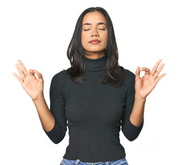 Wall Mural - simple portrait of a young latina relaxes after hard working day, she is performing yoga.