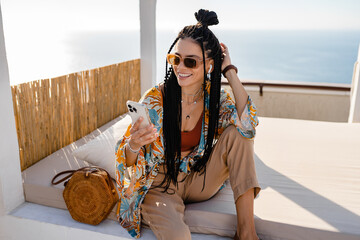 Wall Mural - stylish pretty woman with african braids on sunny summer vacation