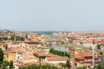 Wall Mural - Florence, Italy. Ponte Vecchio. Medieval arched bridge with souvenir shops. Arno River. Panorama of the city. Summer day