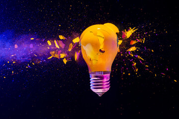 Fototapete - Yellow light bulb exploding black background